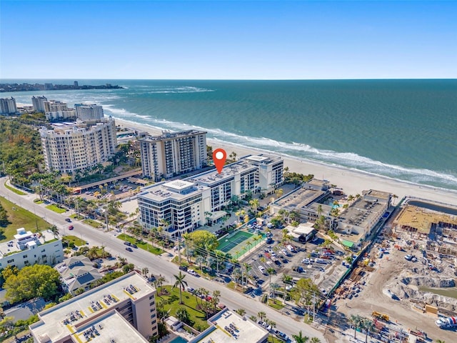 birds eye view of property featuring a water view and a view of the beach