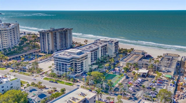 birds eye view of property featuring a water view and a beach view