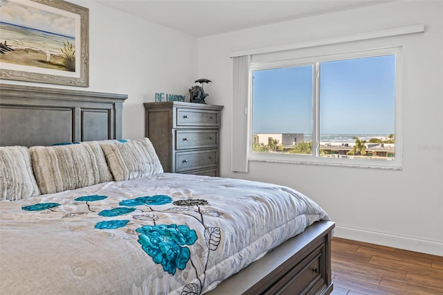 bedroom with wood finished floors and baseboards