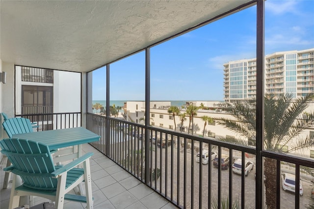 unfurnished sunroom featuring a water view