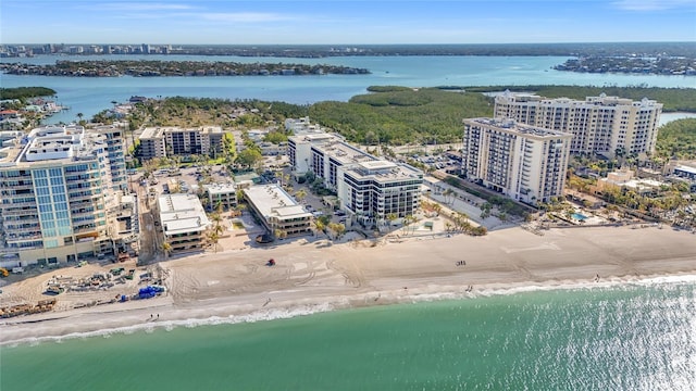 drone / aerial view with a beach view, a view of city, and a water view