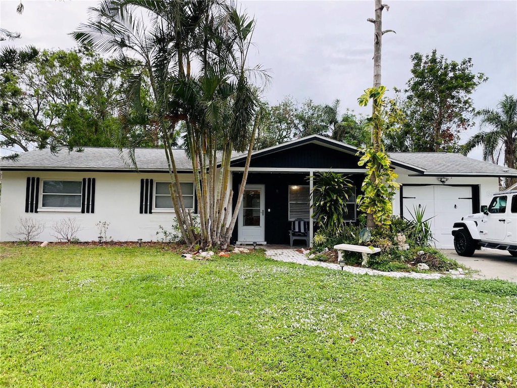 ranch-style home with a front yard and a garage