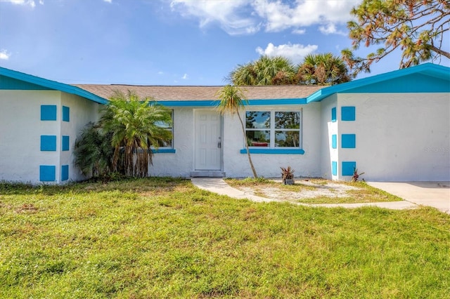 ranch-style home with a front lawn