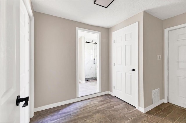 foyer entrance with hardwood / wood-style floors and a textured ceiling