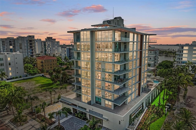 property at dusk with a view of city