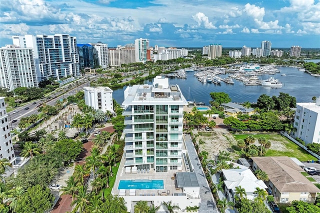 birds eye view of property with a water view and a city view