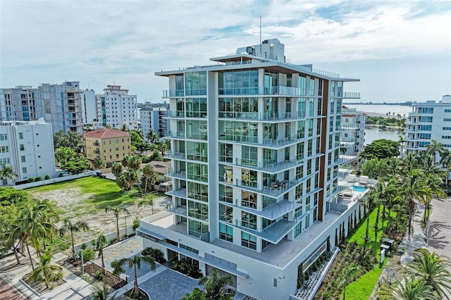 view of building exterior with a city view and a water view