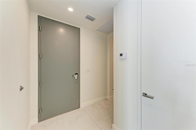 hallway featuring light tile patterned floors, recessed lighting, visible vents, and baseboards