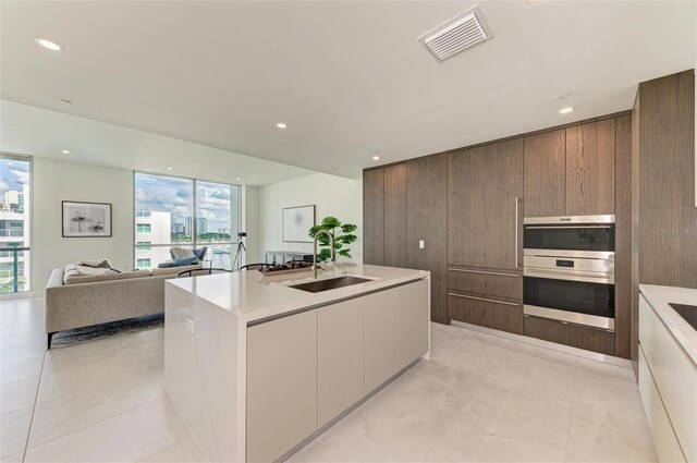 111 Golden Gate Pt Unit 402, Sarasota, FL 34236 - kitchen featuring modern cabinets, a sink, light countertops, recessed lighting, and light tile patterned flooring