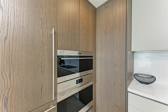 111 Golden Gate Pt Unit 402, Sarasota, FL 34236 - kitchen with oven, light countertops, and modern cabinets