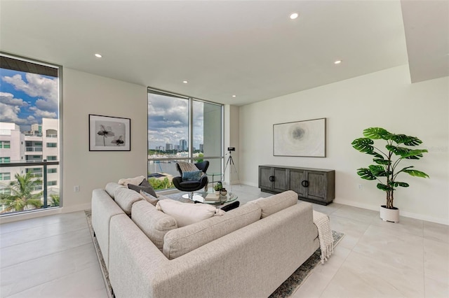 111 Golden Gate Pt Unit 402, Sarasota, FL 34236 - living area featuring a wall of windows, recessed lighting, light tile patterned floors, baseboards, and a city view