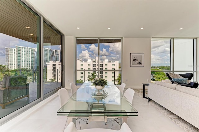 dining space featuring a view of city and floor to ceiling windows