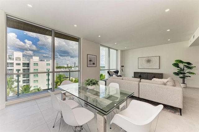 dining space with recessed lighting, floor to ceiling windows, a city view, and light tile patterned floors