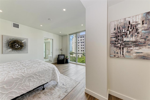 bedroom featuring baseboards, wood finished floors, visible vents, and recessed lighting