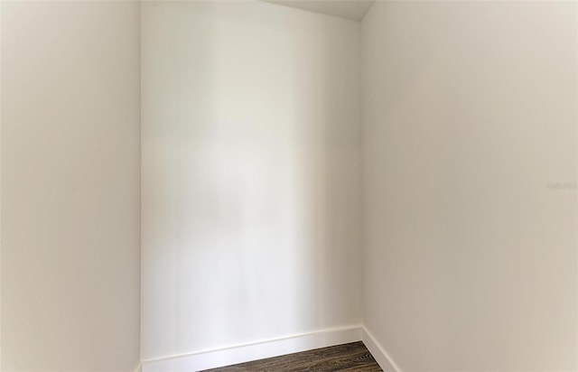 unfurnished room featuring dark wood-style floors and baseboards