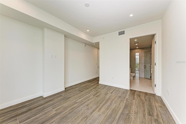 111 Golden Gate Pt Unit 402, Sarasota, FL 34236 - empty room with wood finished floors, recessed lighting, and baseboards