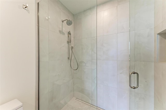 full bath with a shower stall and toilet