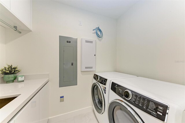 111 Golden Gate Pt Unit 402, Sarasota, FL 34236 - laundry room with electric panel, cabinet space, washer and clothes dryer, and baseboards