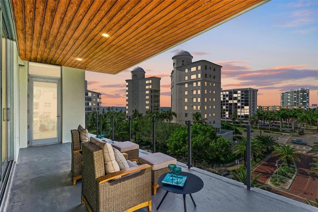 balcony at dusk with a view of city