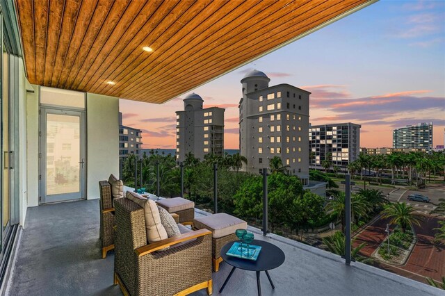 111 Golden Gate Pt Unit 402, Sarasota, FL 34236 - balcony at dusk with a city view