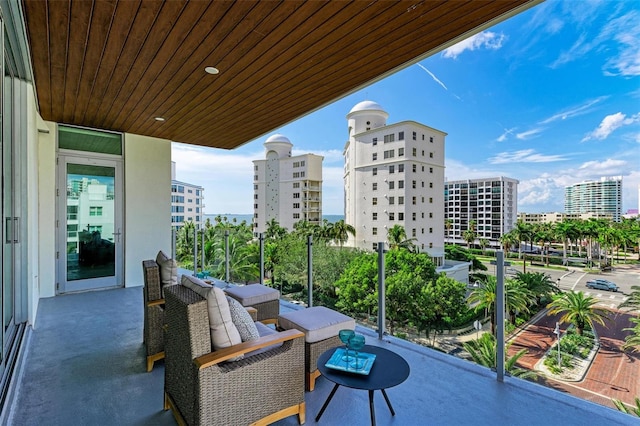 balcony with a view of city and a sunroom