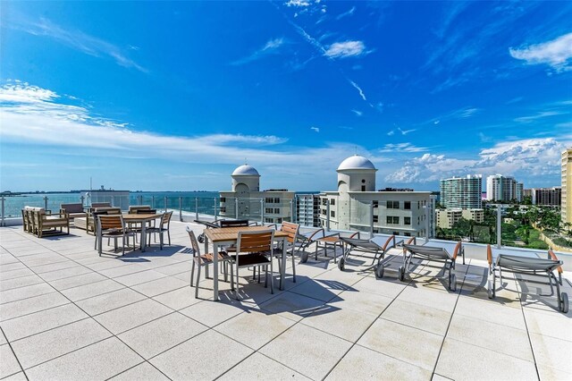 111 Golden Gate Pt Unit 402, Sarasota, FL 34236 - view of patio / terrace featuring a city view, a water view, and outdoor dining space