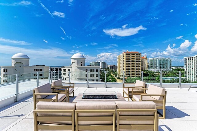 111 Golden Gate Pt Unit 402, Sarasota, FL 34236 - view of patio / terrace featuring an outdoor living space with a fire pit and a city view