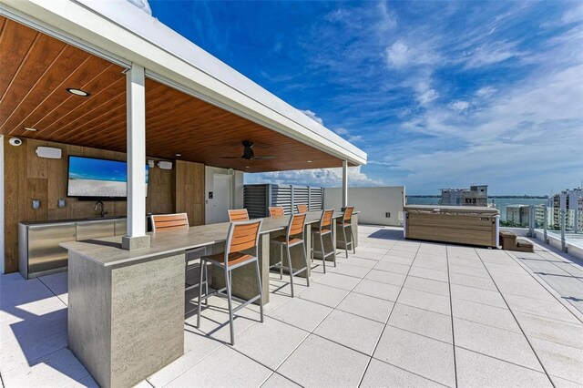 111 Golden Gate Pt Unit 402, Sarasota, FL 34236 - view of patio / terrace featuring a hot tub and a ceiling fan