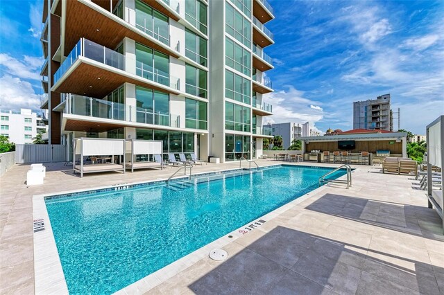 111 Golden Gate Pt Unit 402, Sarasota, FL 34236 - community pool with a patio and an outdoor hangout area