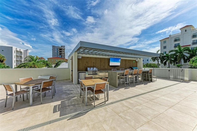 view of patio featuring outdoor dining area, fence, and area for grilling