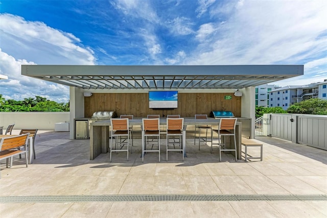 view of patio featuring exterior kitchen and outdoor wet bar