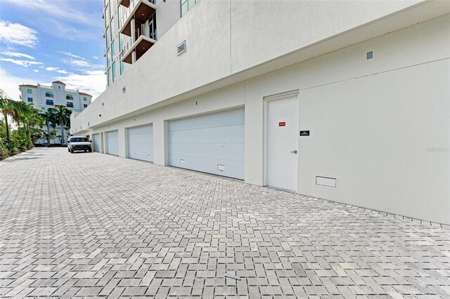 111 Golden Gate Pt Unit 402, Sarasota, FL 34236 - garage featuring decorative driveway