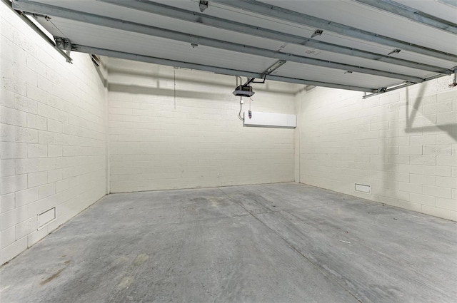 111 Golden Gate Pt Unit 402, Sarasota, FL 34236 - garage with a garage door opener and concrete block wall