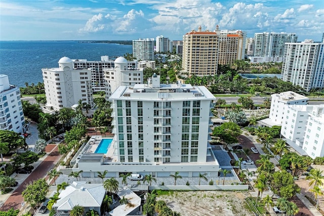 birds eye view of property with a view of city and a water view