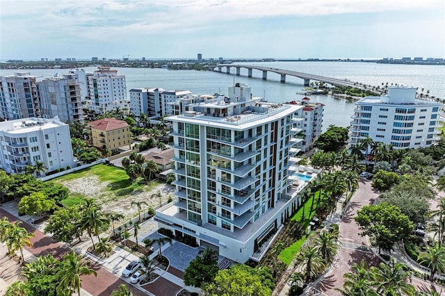 birds eye view of property featuring a water view and a view of city