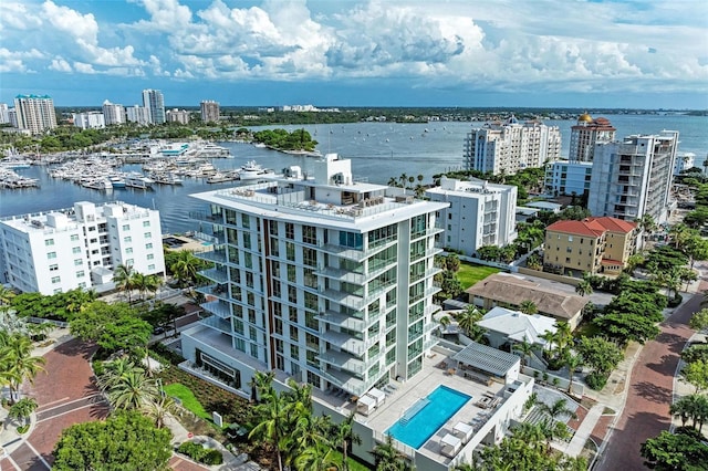 drone / aerial view featuring a view of city and a water view