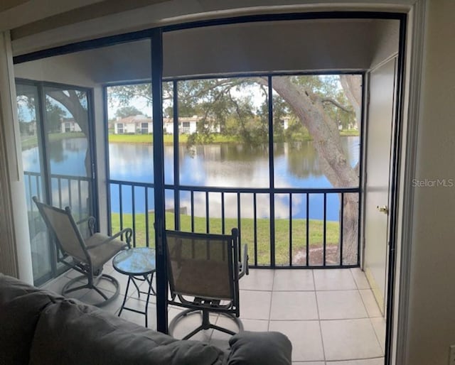 sunroom featuring a healthy amount of sunlight and a water view