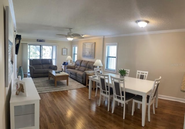 dining room featuring plenty of natural light, ceiling fan, crown molding, and dark hardwood / wood-style flooring