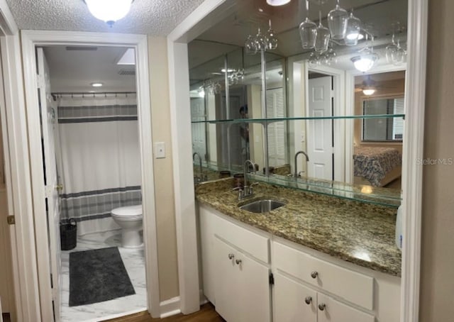 bathroom featuring vanity, a textured ceiling, hardwood / wood-style flooring, curtained shower, and toilet