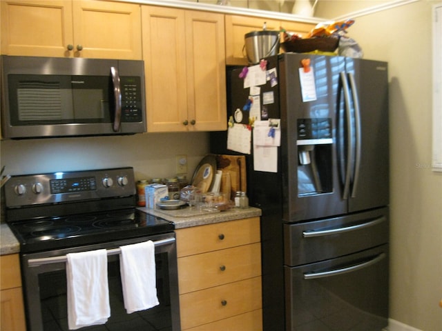 kitchen featuring light brown cabinets and stainless steel appliances