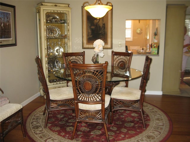 dining room with dark hardwood / wood-style flooring