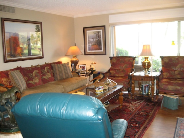 living room featuring hardwood / wood-style flooring and crown molding