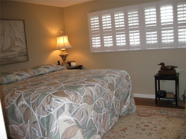 bedroom with hardwood / wood-style floors