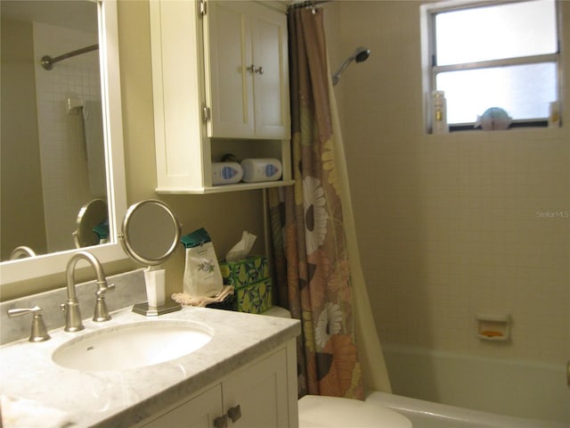 full bathroom with vanity, shower / bath combo with shower curtain, and toilet