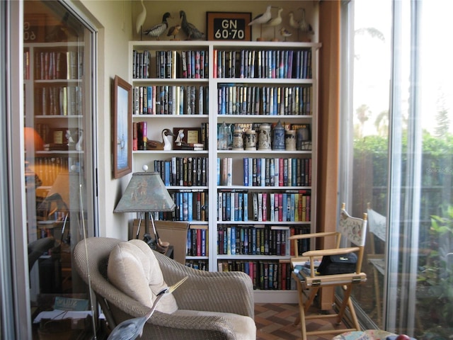 sitting room with parquet flooring and plenty of natural light