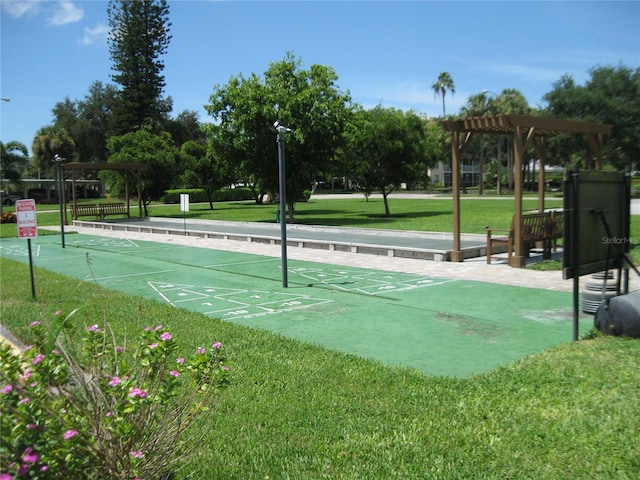 view of home's community with a lawn and a pergola