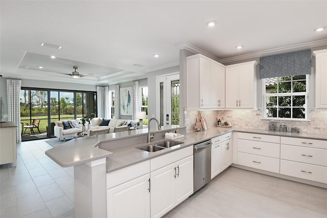 kitchen featuring white cabinetry, kitchen peninsula, dishwasher, and sink