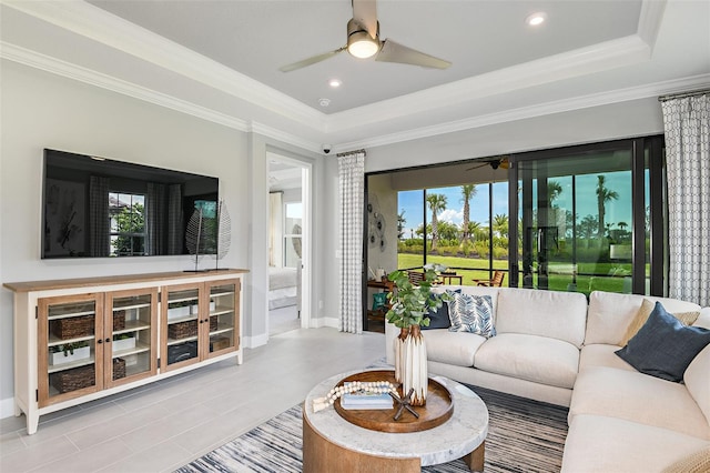 living room featuring a raised ceiling and crown molding