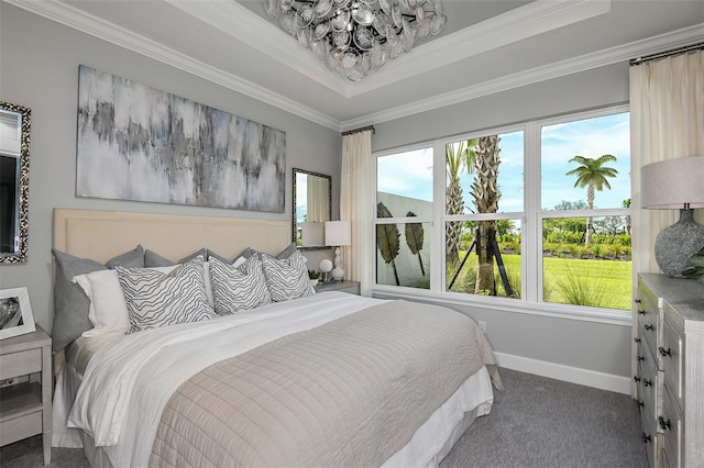 bedroom featuring dark carpet, a raised ceiling, and crown molding