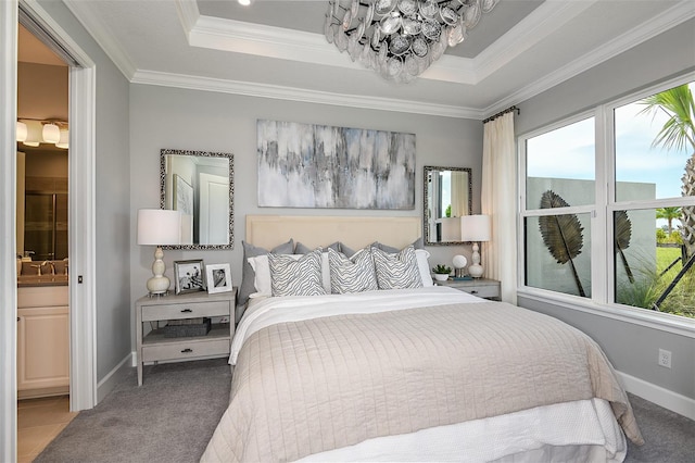 carpeted bedroom with ensuite bathroom, ornamental molding, sink, and a tray ceiling